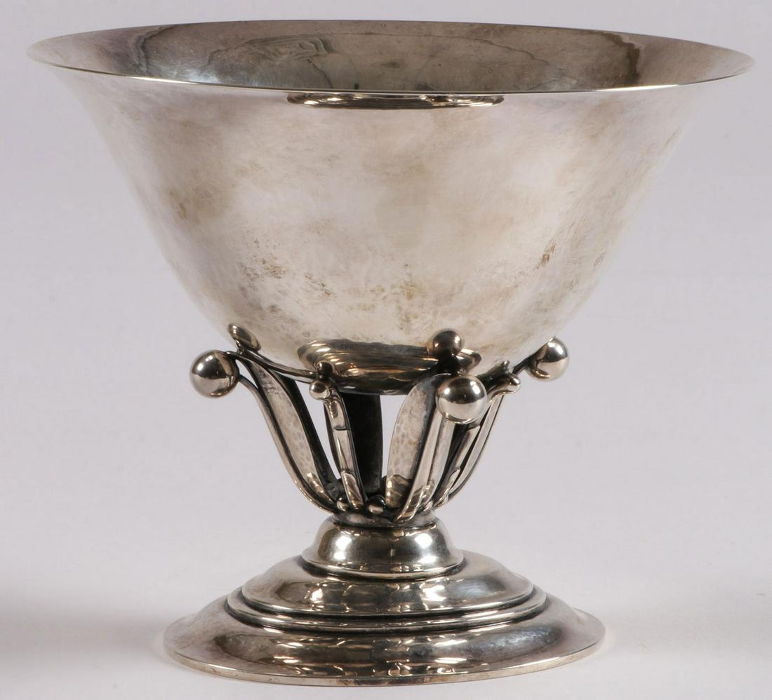 A GEORG JENSEN SILVER COMPOTE: A GEORG JENSEN SILVER COMPOTE. Comprising a Georg Jensen sterling silver compote, pattern number 6, and designer stamp of Johan Rohde, resting on an oval base with openwork stylized flower stems suppo