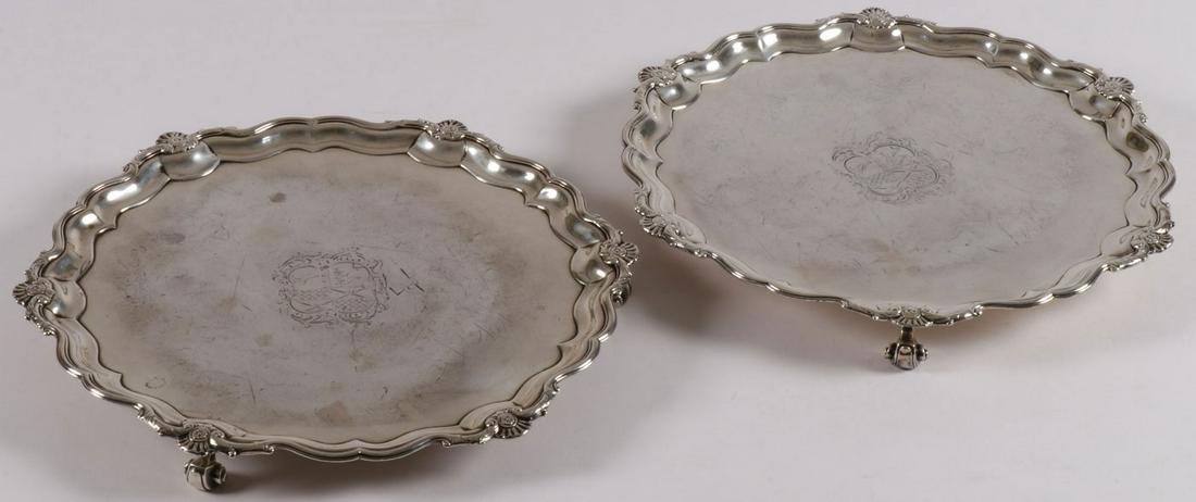 A PAIR OF GEORGE II SILVER SALVERS LONDON 1747: A PAIR OF GEORGE II SILVER SALVERS LONDON 1747. Comprising a pair of matching silver salvers, resting on three scroll feet with scalloped rim interspersed with shell forms and the cavetto with engrave
