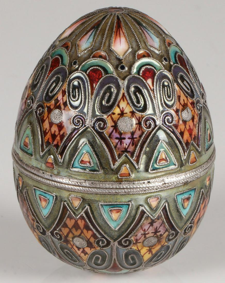 A RUSSIAN SILVER & ENAMEL EASTER EGG MOSCOW 1908-: A RUSSIAN SILVER & ENAMEL EASTER EGG MOSCOW 1908-1917. Comprising a very fine silver and shaded enamel two-piece Easter egg enameled in scrolling, geometric and fish scale designs in graduated shades