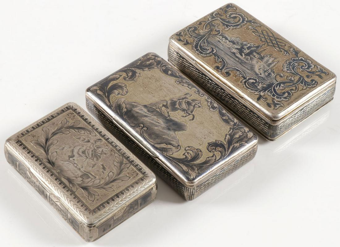 THREE RUSSIAN SILVER & NIELLO SNUFF BOXES, 19TH C: THREE RUSSIAN SILVER & NIELLO SNUFF BOXES, 19TH C. Comprising three silver and niello decorated snuff boxes, Two examples with the hinged lid decorated with the famous sculpture The Bronze Horseman”