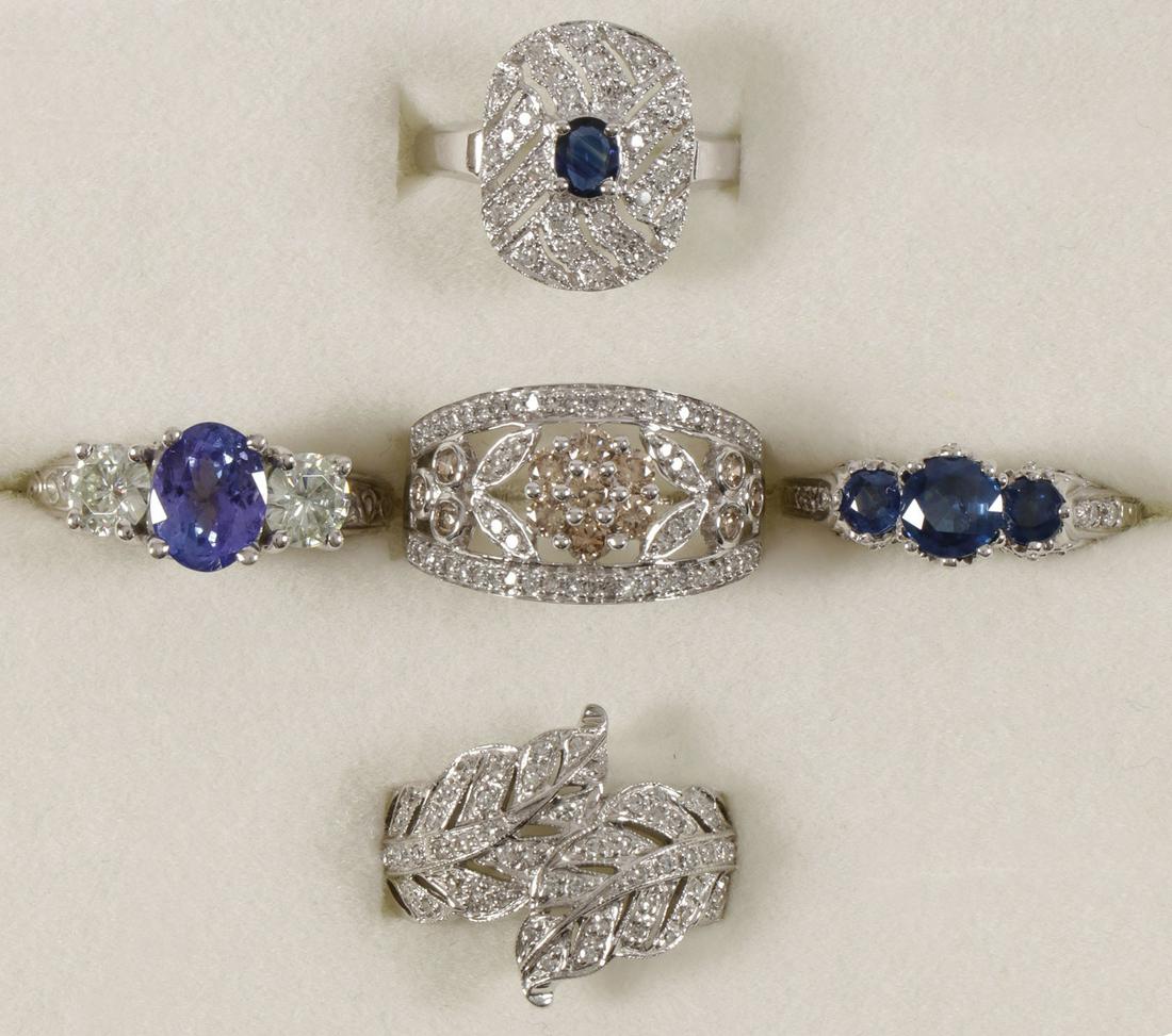 FIVE LADIES ELEGANT 14KT GOLD RINGS: FIVE LADIES ELEGANT 14KT GOLD RINGS. Comprising five individual elegantly fashioned ladies cocktail rings in 14kt white gold set with various gemstones as pictured including tanzanite, sapphire, and m