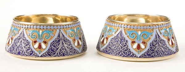Pair Russian silver-gilt and enamel salts: A PAIR OF RUSSIAN SILVER-GILT AND CLOISONNE ENAMELED SALTS. The sides profusely enameled on a stippled ground, the interiors brightly gilded. Diameter 2.3 inches (6 cm). Indistinguishably marked. Esti