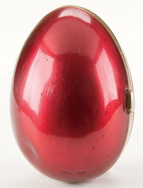 Russian silver coin purse: A UNIQUE RUSSIAN SILVER AND LACQUERED EGG FORM COIN PURSE, St. Petersburg, 1899-1908. The hinged halved with push button release opening to reveal accordion silk coin compartments. Hallmarked St. Pete