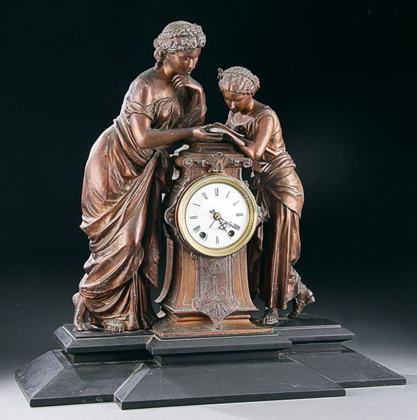 Seth Thomas Victorian mantle clock: A LARGE SETH THOMAS FIGURAL VICTORIAN MANTLE CLOCK late 19th century, of a pair of spelter classical women reading a book raised on a shaped iron plinth. Height 20 inches. Estimate $300-$500