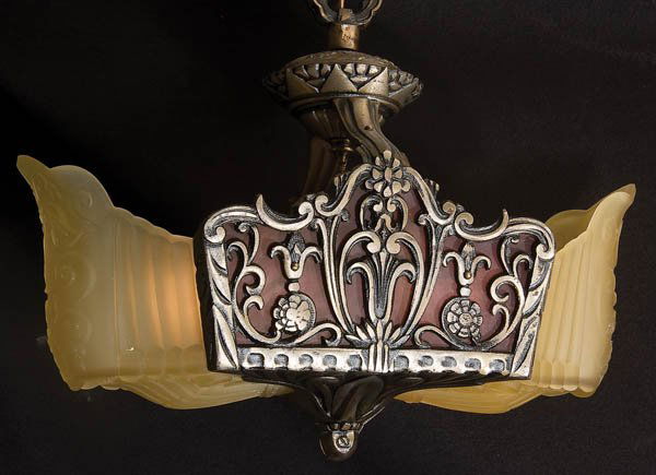 ART DECO GLASS AND TWO-LIGHT HALL FIXTURE: AN ART DECO MOLDED GLASS AND FILIGREE METAL TWO-LIGHT HALL FIXTURE early 20th century, amber glass shaded and a variegated burnt orange panel behind a filigree frame. Height 19 inches, width 14.5 inch