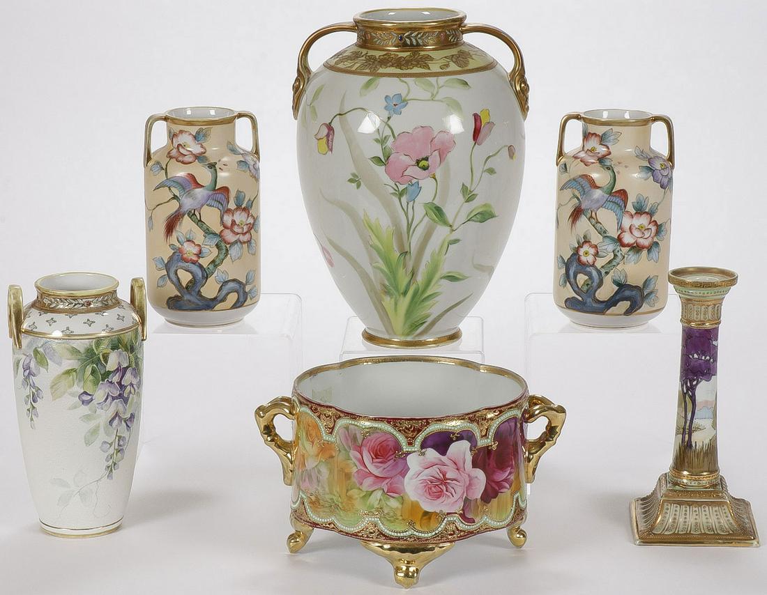 SIX PIECES OF NIPPON PORCELAIN: SIX PIECES OF NIPPON PORCELAIN. Including a large double handled floral decorated vase, a footed compote with ribbed sides, a pair of matching vases, a candlestick, and at lower left an interesting do