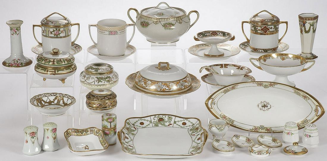 70 PIECES OF NIPPON PORCELAIN: 70 PIECES OF NIPPON PORCELAIN. A large and impressive array of ornately decorated Nippon porcelain including condensed milk holders, hair receivers, covered bowls, platters, plates, shakers, and vases