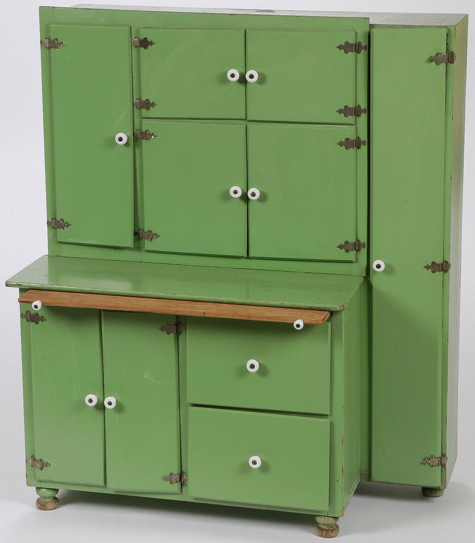 CHILD'S KITCHEN CUPBOARD BY TRIANG: CHILD'S KITCHEN CUPBOARD BY TRIANG. Comprising an original green painted children's kitchen cupboard with pull out dough board, porcelain knobs, and original hardware, as well as Triang manufacturers 