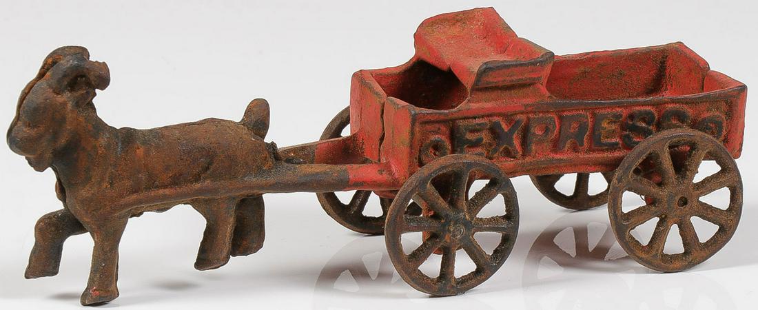 A CAST IRON EXPRESS GOAT CART: A CAST IRON EXPRESS GOAT CART. An orange cast iron wagon embossed on either side with the word 'express' being pulled by a goat. Without driver. Length 8 inchesSHIPPING NOTICE:Jackson's is your