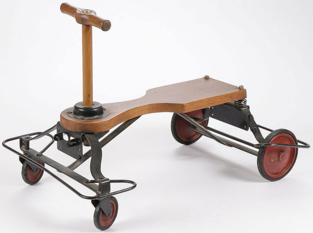 A VINTAGE CHILD: A VINTAGE CHILD'S SCOOTER. Overall length 24 inches, height 17 inches. SHIPPING NOTICE: Jackson's is your sole and only source for one stop packing and shipping. With over 50 years of experience, our