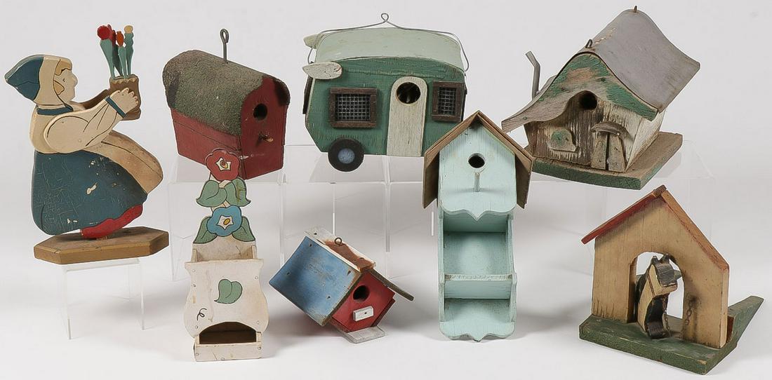 A PRIMITIVE & FOLKART BIRDHOUSE COLLECTION: A PRIMITIVE & FOLKART BIRDHOUSE COLLECTION. Comprising five early to mid 20th century painted wood bird houses including a winged camper. Together with two figural novelty door stops and a match holde