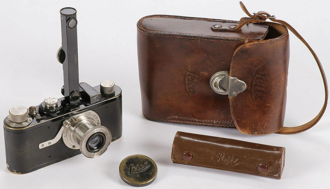 A LEICA I (MODEL A) 35MM CAMERA, CIRCA 1929: A LEICA I (MODEL A) 35MM CAMERA, CIRCA 1929. Comprising a Leica I Model A camera, the first mass produced 35mm camera, by Leitz camera company with 50mm f/3.5 Elmar lens serial #18670. Together with a