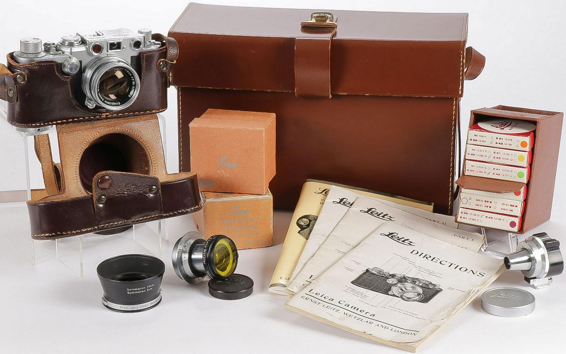 LEICA MODEL IIIF CAMERA AND ACCESSORIES C 1953: LEICA MODEL IIIF CAMERA AND ACCESSORIES CIRCA 1953. Comprising a Leica Model IIIf rangefinder camera with serial number 667524 contained in a leather carrying case embossed "Leica" on front and "E. Le