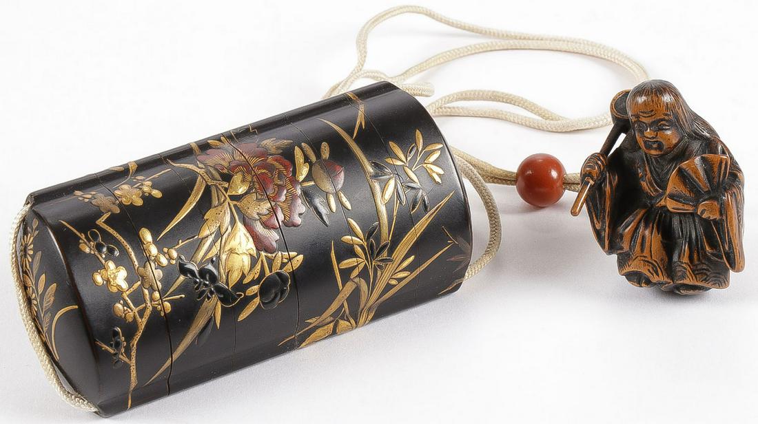 FINE JAPANESE LACQUER INRO, EDO: FINE JAPANESE LACQUER INRO, EDO. Comprising a five-section black lacquered inro with heavy gilt floral decoration and metallic rust hued interior, the chord with lacquered Ojime bead and carved wood n