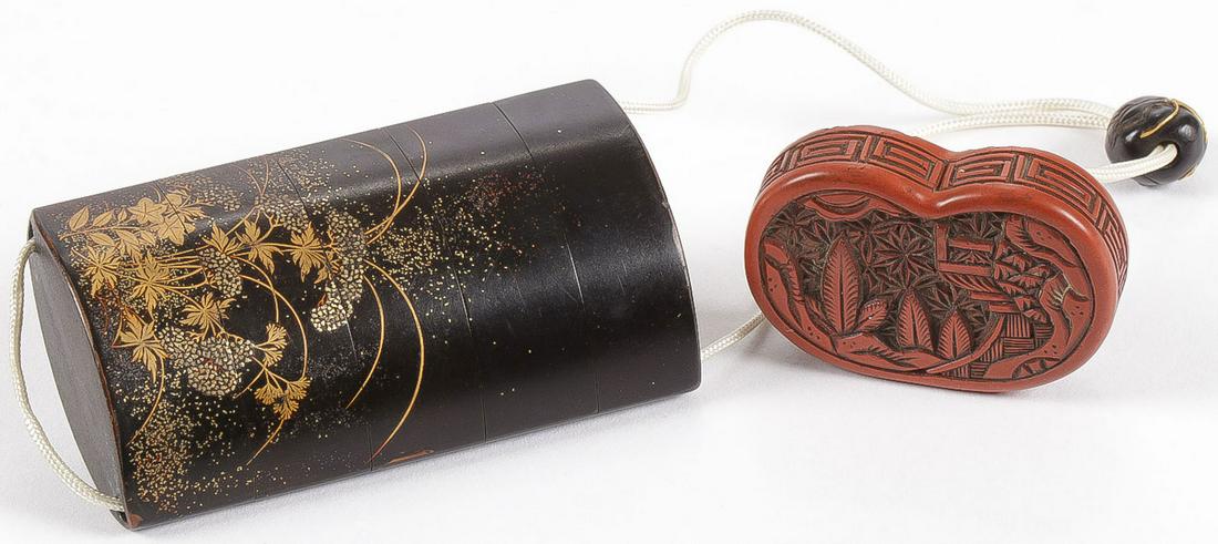 FINE JAPANESE LACQUER INRO, EDO: FINE JAPANESE LACQUER INRO, EDO. Comprising a five-section black lacquered inro with heavy gilt decoration depicting blossoming plants, the interior of metallic rust hue, chord with carved Ojime bead 