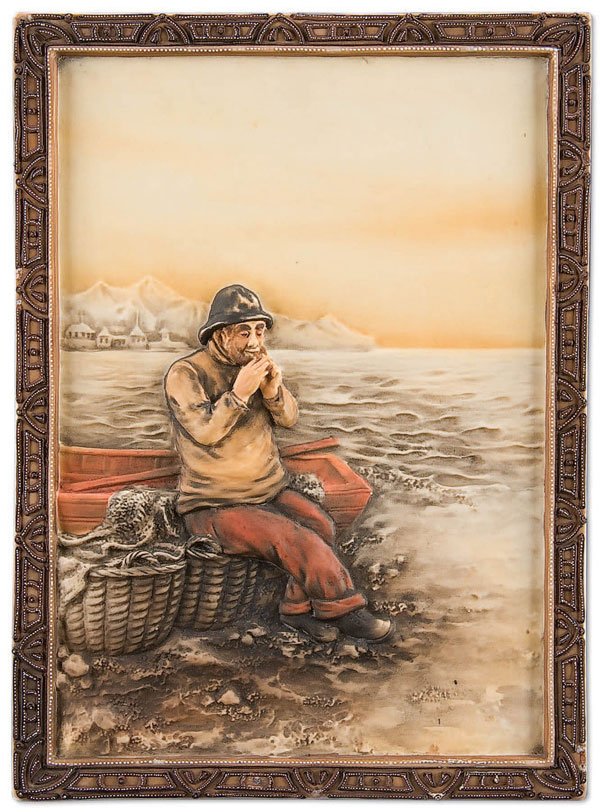 NIPPON FISHERMAN PORCELAIN PLAQUE: A RARE HAND PAINTED NIPPON 'FISHERMAN' PORCELAIN PLAQUE early 20th century, with sculpted molded in relief scene of a fisherman smoking a pipe within a moriage self framed border. Green M in wreath ma