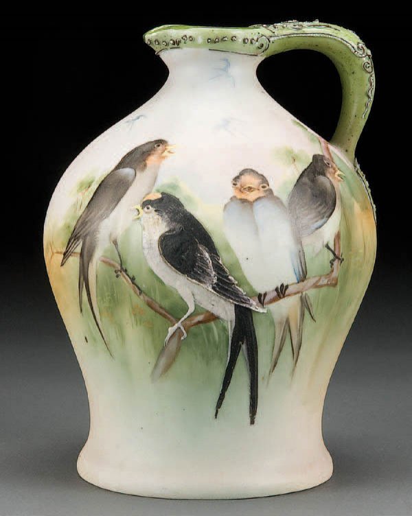 NIPPON MORIAGE WHISKEY JUG: A HAND PAINTED NIPPON MORIAGE DECORATED WHISKEY JUG early 20th century, with scene of four birds on a branch, the central bird with moriage highlights. Stopper absent. Blue maple leaf mark. Height 8 i