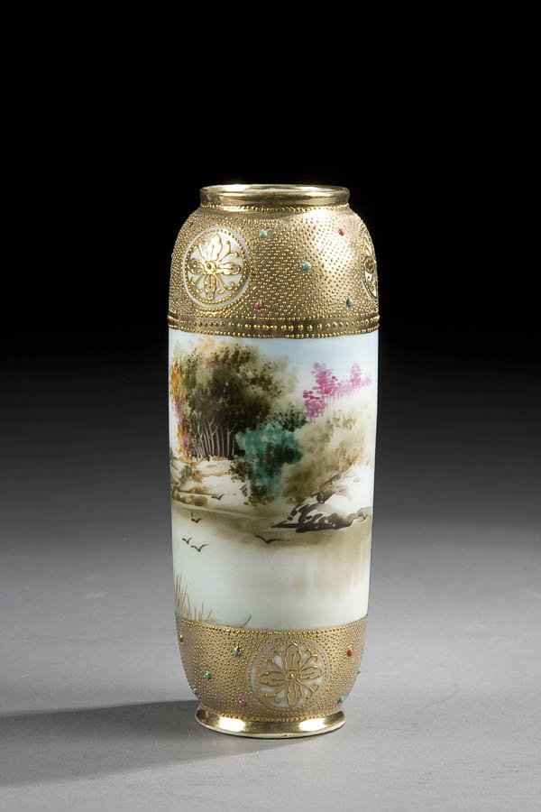 A FINE NIPPON JEWELED SCENIC VASE early 20th cent: A FINE NIPPON JEWELED SCENIC VASE early 20th century, with lakeshore scene. Blue maple leaf mark. Height 6.5 inches. Estimate $100-$150 Reference: This piece is the actual item illustrated in Plate 34