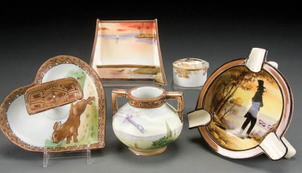 5 HAND PAINTED NIPPON PORCELAIN CABINET PIECES ea: 5 HAND PAINTED NIPPON PORCELAIN CABINET PIECES early 20th century, consisting of a silhouette portrait ashtray, a running rabbit heart-shape cigar stand, a Nile scene sunset calendar holder advertisin
