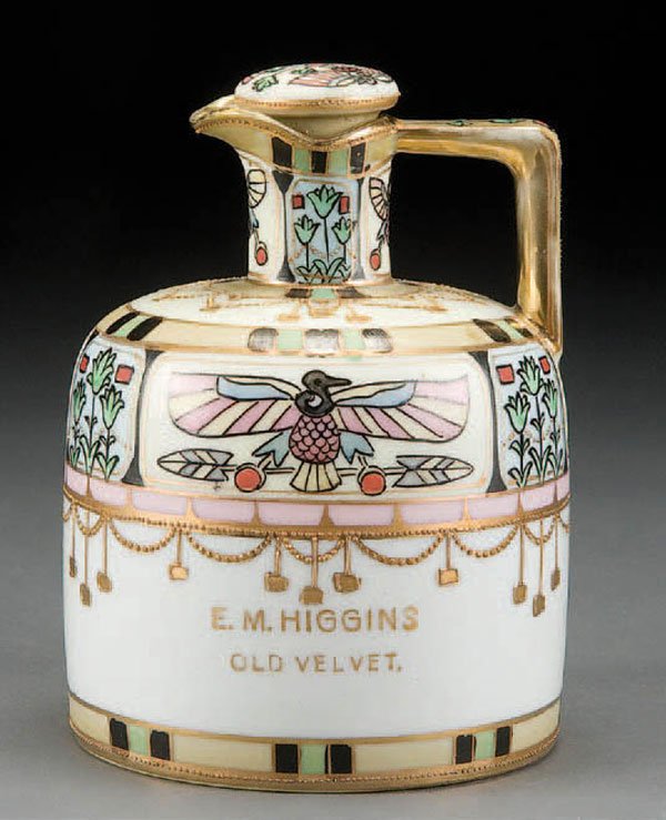 NIPPON E.M. HIGGINS OLD VELVET ADVERTISING WHISKEY : HAND PAINTED NIPPON 'E.M. HIGGINS OLD VELVET' ADVERTISING WHISKEY JUG with stylized Egyptian decoration. Green M in wreath mark. Height 6 inches. Estimate $200-$400