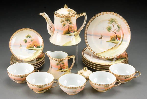 A HAND PAINTED NIPPON PORCELAIN TEA SET early 20t: A HAND PAINTED NIPPON PORCELAIN TEA SET early 20th century, 17 piece with house in meadow decoration. TT mark. Estimate $100-$200