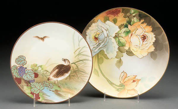 A PAIR OF HAND PAINTED NIPPON PORCELAIN PLAQUES e: A PAIR OF HAND PAINTED NIPPON PORCELAIN PLAQUES early 20th century, of yellow roses and a grouse with enameled berries. Green M in wreath marks. Diameter 9 & 10 inches. Estimate $100-$200