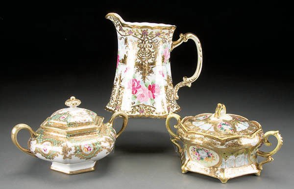 2 HAND PAINTED NIPPON GILT DECORATED BISCUIT JARS: 2 HAND PAINTED NIPPON GILT DECORATED BISCUIT JARS early 20th century, together with a milk pitcher. RC, green and blue maple leaf marks. Largest height 8.5 inches. Estimate $100-$200