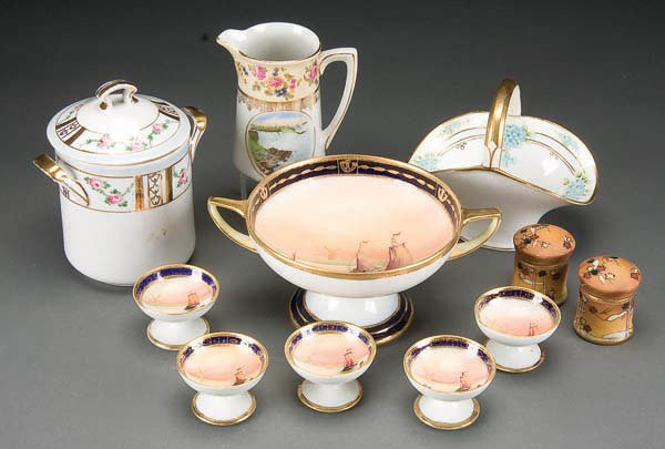 11-PIECE HAND PAINTED NIPPON TABLEWARE GROUP earl: 11-PIECE HAND PAINTED NIPPON TABLEWARE GROUP early 20th century, consisting of a 6-piece scenic decorated pedestal nut set, handled basket, cream jug and condensed milk container. Mostly M in wreath m