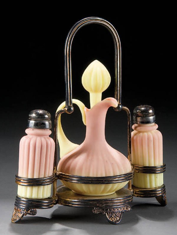 A MT. WASHINGTON BURMESE 3-PIECE CONDIMENT SET la: A MT. WASHINGTON BURMESE 3-PIECE CONDIMENT SET late 19th century. Consisting of a cruet and 2 shakers in a silvered Pairpoint frame. Cruet with crack near handle. Height 9.5 inches. Estimate $200-$400