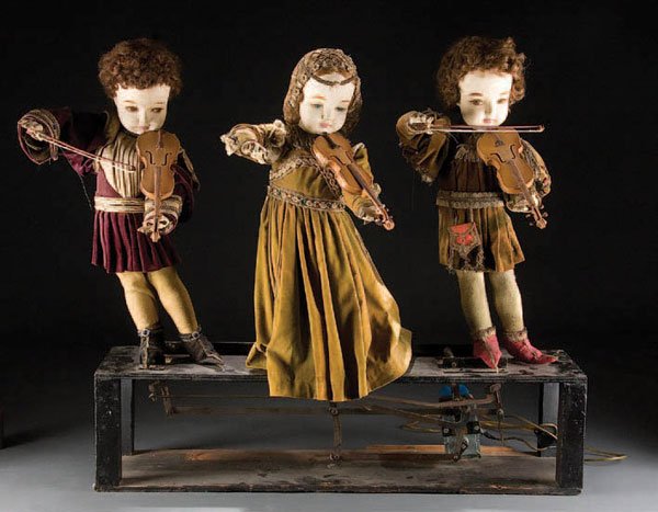 A VIOLIN STORE ANIMATRON mid 20th century, with 3: A VIOLIN STORE ANIMATRON mid 20th century, with 3 Shakespearean clothed figures holding violins (figures rock back and forth). Height 30 inches. Estimate $200-$400