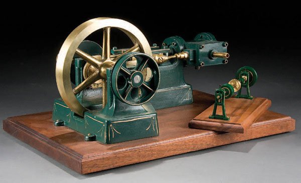 A MACHINIST MADE LIVE STEAM ENGINE late 20th Cent: A MACHINIST MADE LIVE STEAM ENGINE late 20th Century engine with 1 inch cylinder driving a 6 inch bronze wheel. Length 20 inches. Estimate $50-$100