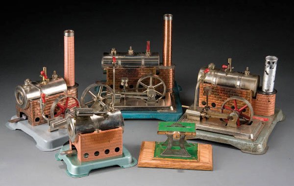 A JENSEN MFG AND WEEDEN TOY STEAM ENGINE group in: A JENSEN MFG AND WEEDEN TOY STEAM ENGINE group including a Jensen dry fuel fire engine style no. 85, Jensen style no. 63, a Jensen style no. 65 together with a Weeden tablesaw. Estimate $150 - $150