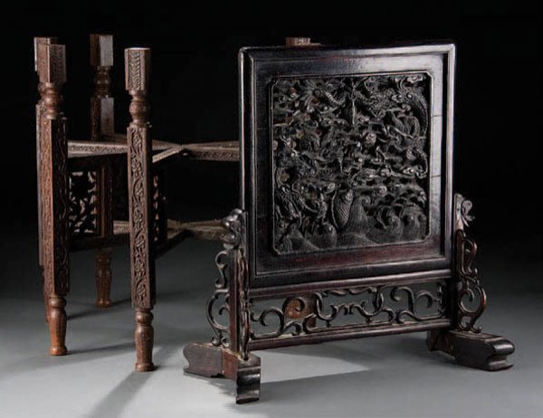 A CHINESE ART DECO CARVED MAHOGANY TABLE SCREEN, : A CHINESE ART DECO CARVED MAHOGANY TABLE SCREEN, Peking circa 1925. With reticulated panel scene dragons and coy fish within stylized clouds, contained in a carved scrollwork base. Height 18 inches. T