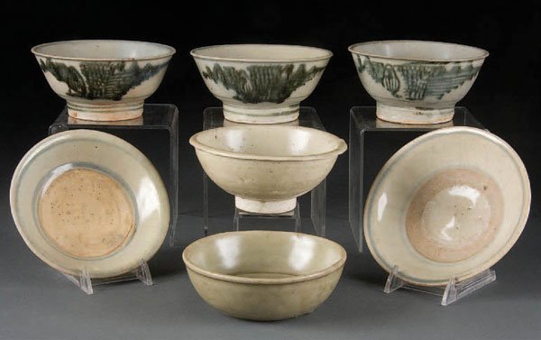 7 ASIAN CERAMICS comprising 4 Southeast Asian cel: 7 ASIAN CERAMICS comprising 4 Southeast Asian celadon or blue/white bowls and shallow plates with exposed clay interiors and potching, 3 matching blue/white high-footed bowls of Chinese export style f
