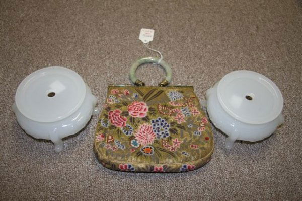 A CHINESE CARVED JADE AND TAPESTRY COIN PURSE ear: A CHINESE CARVED JADE AND TAPESTRY COIN PURSE early 20th century, height 9 inches. Together with a pair of white jadeite style glass stands. Estimate $100-$200