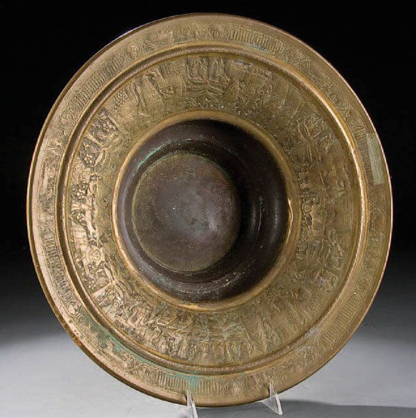AN EGYPTIAN REVIVAL BRONZE TORCHIERE BOWL. Probab: AN EGYPTIAN REVIVAL BRONZE TORCHIERE BOWL. Probably early 20th Century, with hand chaised Egyptian scenery of sphinxes, sarcoughagas and pyramids under gilt reminants. Diameter 16.5". Estimate $100-$2