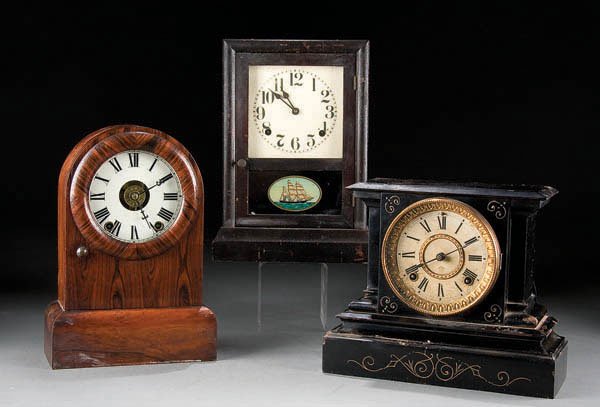 A GROUP OF THREE SHELF CLOCKS, consisting of a do: A GROUP OF THREE SHELF CLOCKS, consisting of a dome Seth Thomas eight day clock, a Sessions with reverse painted ship at sea and a cast iron Ansonia shelf clock. Height 13 inches. Estimate $100 - $150