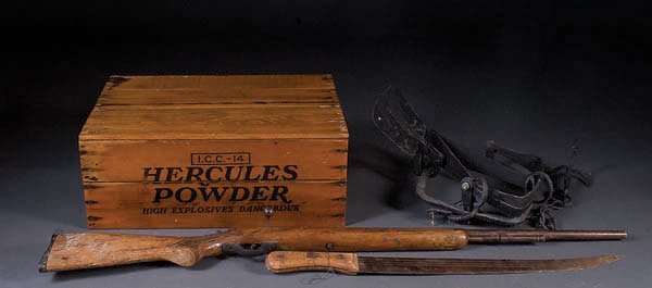 A HERCULES POWDER BOX AND IRON BEAR TRAP together: A HERCULES POWDER BOX AND IRON BEAR TRAP together with an English machete, and relic rifle. Estimate $50-$100