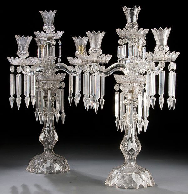 THREE ARM FRENCH CUT CRYSTAL MANTEL LUSTER'S, A P: THREE ARM FRENCH CUT CRYSTAL MANTEL LUSTER'S, A PAIR, 19th century, probably Baccarat baluster stemmed four light luster's with hanging prisms, minor losses. Height 22 inches. Estimate $300-$500 Euro