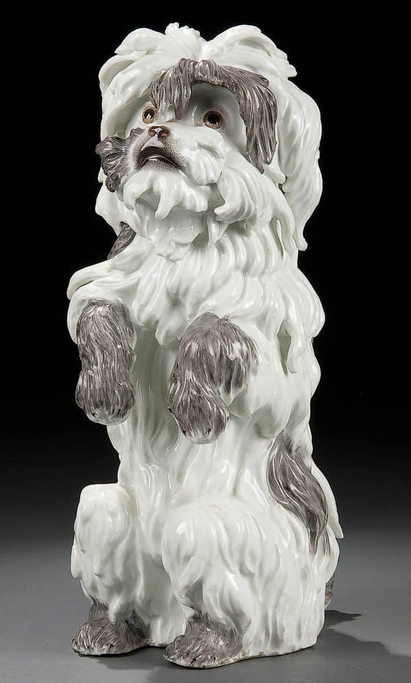 A 19TH C. MEISSEN OR MEISSEN STYLE PORCELAIN DOG: A 19TH C. MEISSEN OR MEISSEN STYLE PORCELAIN DOG depicted in upright sitting form with painted features and scrolling locks. Indistinct blue crossed mark underglaze. Height 12 inches (30 cm). Estimate