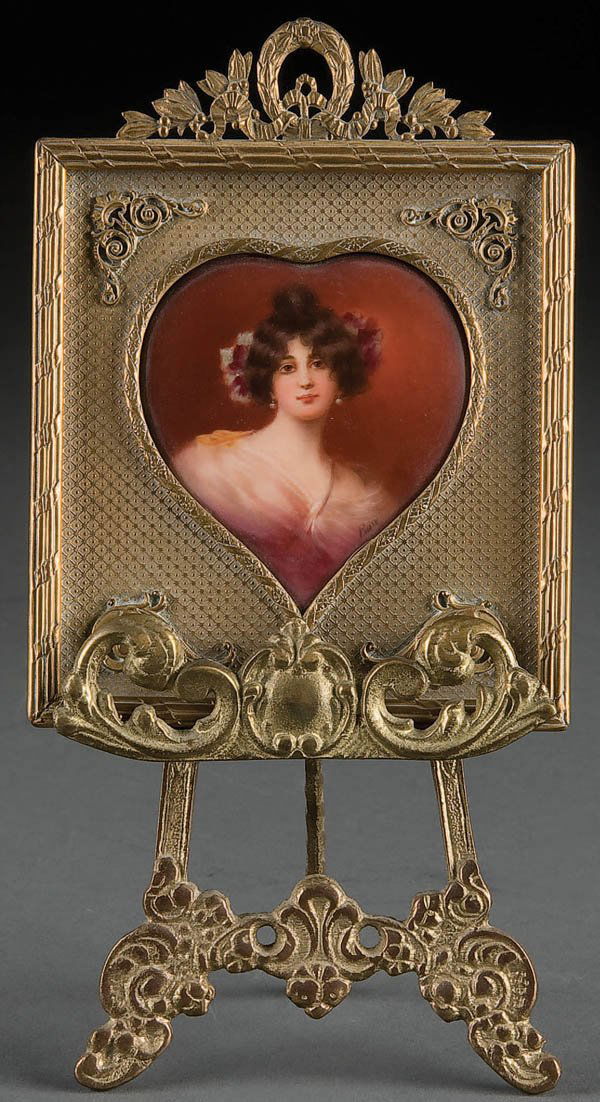 A KPM STYLE HAND PAINTED PORCELAIN PLAQUE circa 1: A KPM STYLE HAND PAINTED PORCELAIN PLAQUE circa 1900, the heart shape plaque with Portrait of a Young Beauty inscribed on verso "Graziella Lichel" and impressed pseudo "KPM" with scepter. Contained in