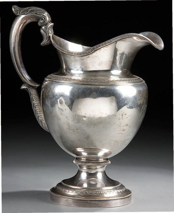 AN EARLY AMERICAN COIN SILVER WATER JUG Philadel: AN EARLY AMERICAN COIN SILVER WATER JUG Philadelphia, circa 1825 with sculpted acanthus handle and arrow leaf border decoration. John Curry silversmith/retailer stamp over William Mannerback marks. He