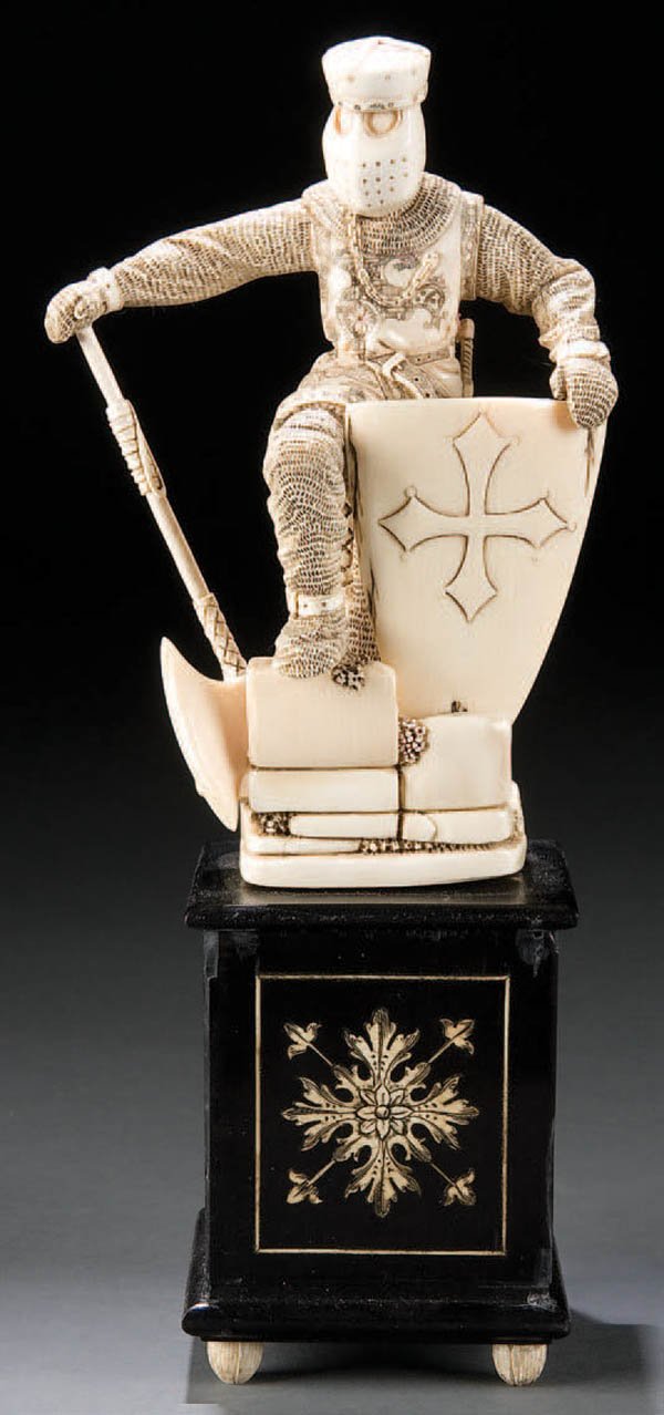 A VERY FINE CARVED IVORY FIGURE of a knight, 19th: A VERY FINE CARVED IVORY FIGURE of a knight, 19th century. Exquisitely carved in full round with exacting detail throughout and resting on an ebonized wood plinth with ivory inlay and ivory bun feet. 