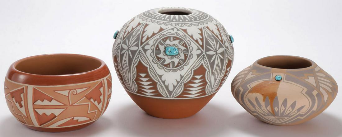THREE POLYCHROMED & DECORATED JARS: THREE POLYCHROMED & DECORATED JARS. Comprising a redware jar with carved panels and polychrome decoration, signed on underside Rosita DeHerrera San Juan Pue. N.M., height 4 inches, diameter 7 inches,
