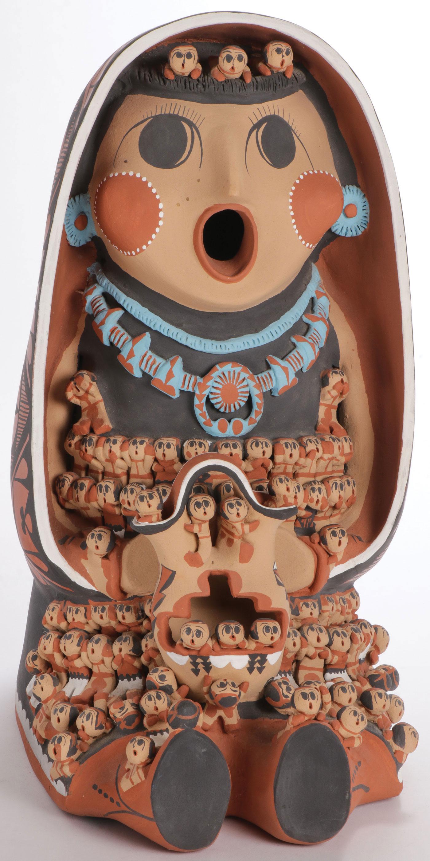 LARGE CAROLINE SANDO STORYTELLER: LARGE CAROLINE SANDO STORYTELLER. The large and impressive polychrome story teller figure traditionally decorated and signed on base C. Sando Jemez Pueblo, New Mexico, and with adobe monogram. Overall