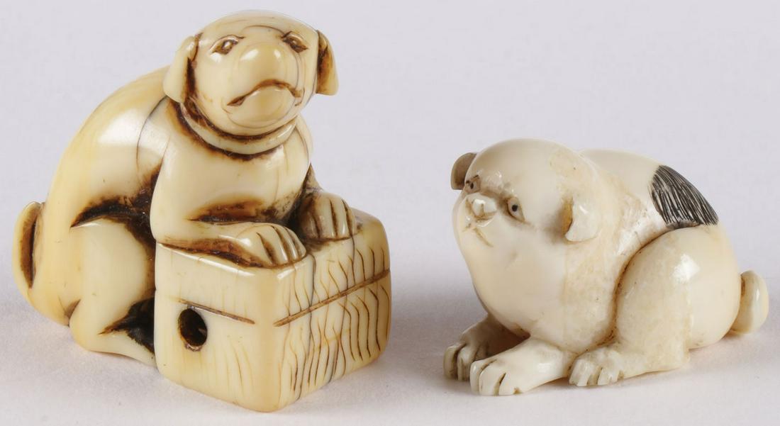 TWO JAPANESE CARVED NETSUKES, EDO: TWO JAPANESE CARVED NETSUKES, EDO. Each depicting a dog. Example on the right signed on underside. The first with a good amount of wear and patination. Greatest measurement 1.5 inches (4 cm). NO INTER