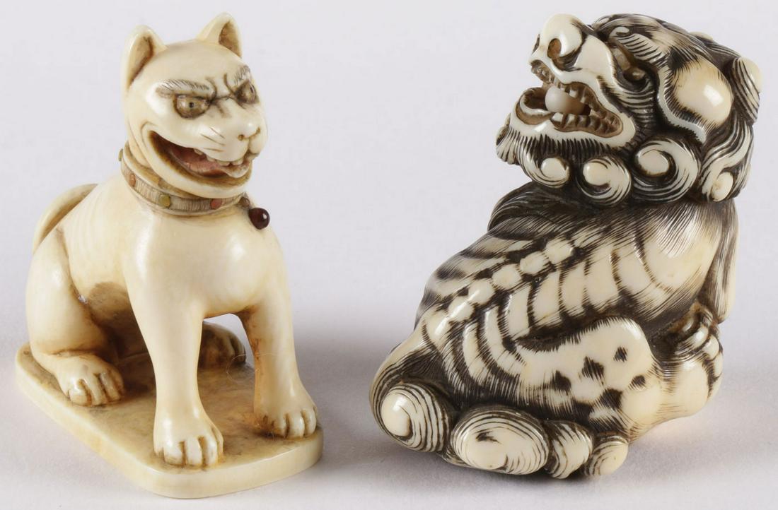 TWO JAPANESE CARVED NETSUKES, EDO: TWO JAPANESE CARVED NETSUKES, EDO. Comprising a seated cat with cabochon decorated collar, inset eyes, and carved with open mouth, tongue and teeth. And a foo lion with inset eyes and the mouth with a