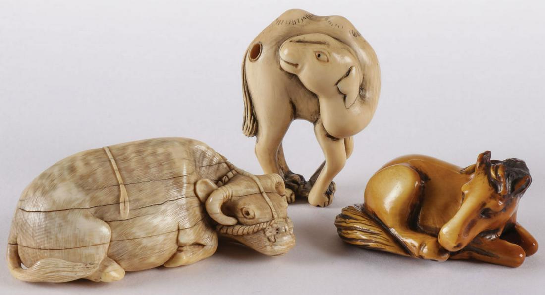 THREE CARVED JAPANESE NETSUKES: THREE CARVED JAPANESE NETSUKES. Comprising three carved netsukes, each modeled as an animal, probably Meiji period. Including an ox, signed, a camel, signed, and a recumbent horse, also signed. Greate