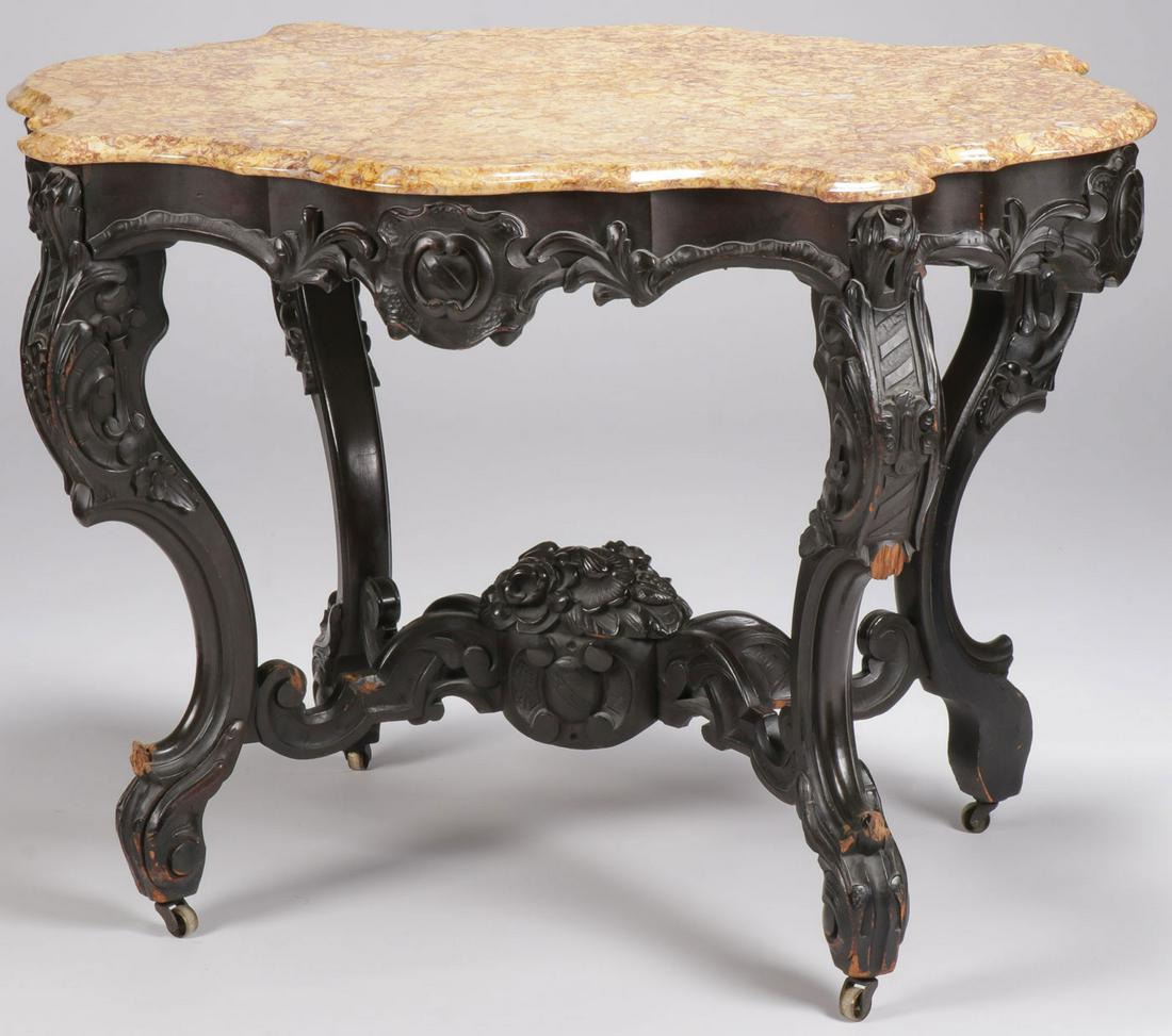 ROCOCO REVIVAL MARBLE TOP TABLE: ROCOCO REVIVAL MARBLE TOP TABLE. Comprising an ornate and heavily carved table, the beveled marble top over conforming frieze with applied heavily carved foliage raised on four cabriole legs terminati