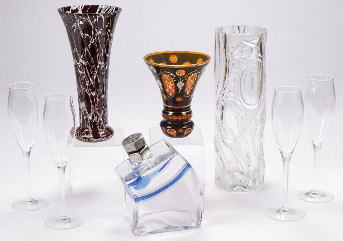 ART GLASS GROUP INCL. CARTIER: ART GLASS GROUP INCL. CARTIER. Comprising a cased set of four Cartier footed champagnes, a Kosta Boda decanter with screw on lug shaped stopper, as well as a ruby stretched glass vase, a modern clear 